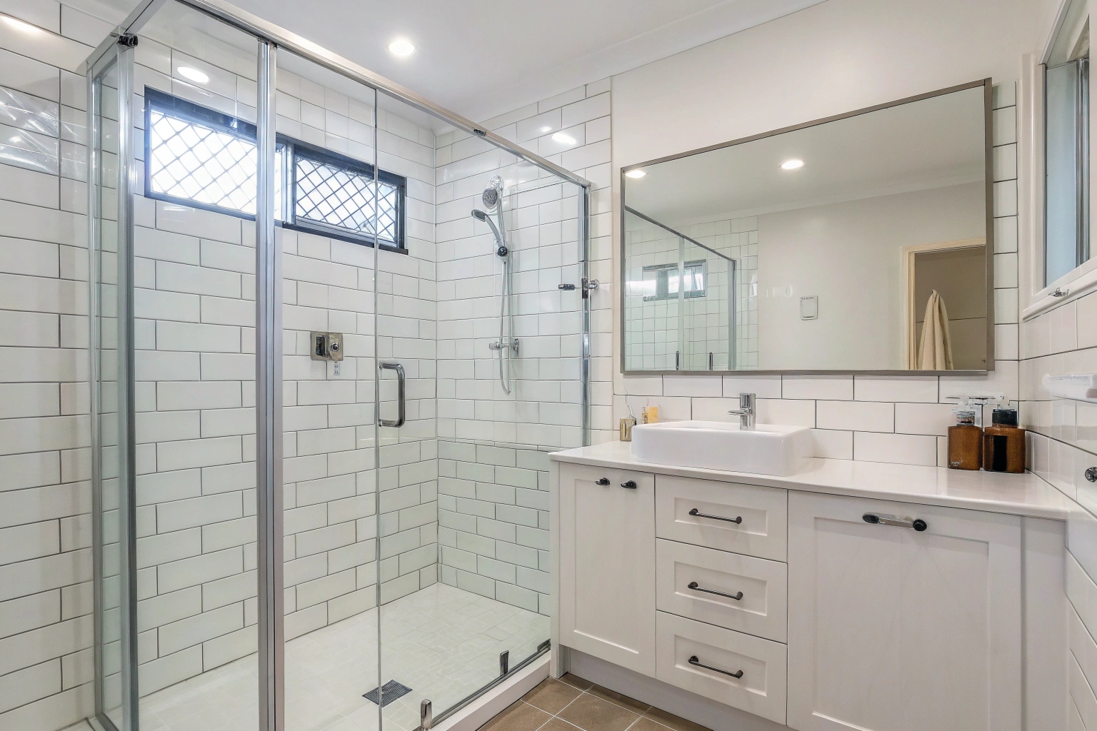 Clean contemporary bathroom with frameless shower screen after professional bond clean